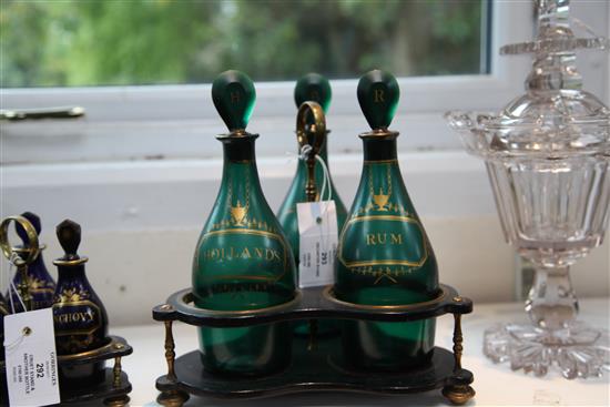 A Regency gilt decorated green glass three bottle decanter stand, total height 26cm